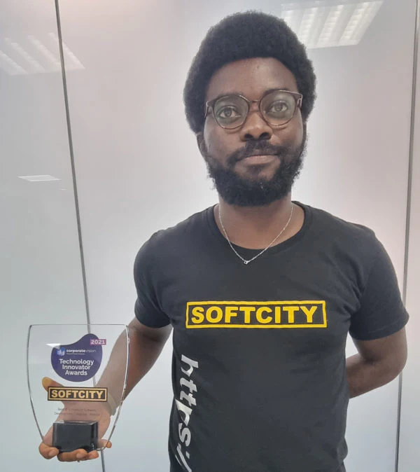 A Softcity team member holds the 2021 Technology Innovator Award.