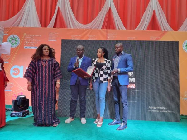Softcity representatives receive a technology recognition on stage.