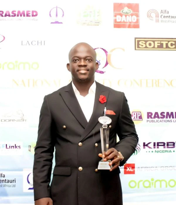 Dr. Stephen Adetutu Oniya holds the National Quality Conference trophy.