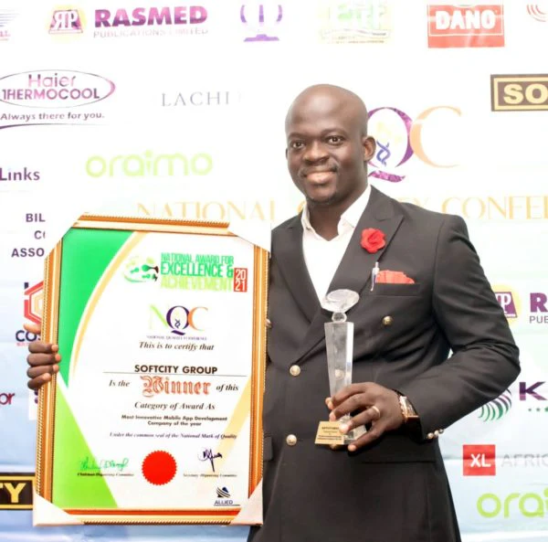 Dr. Stephen Adetutu Oniya displays Softcity Group’s National Quality recognition and trophy.