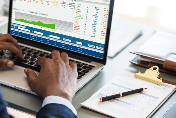 Business analytics displayed on a laptop in a working environment.